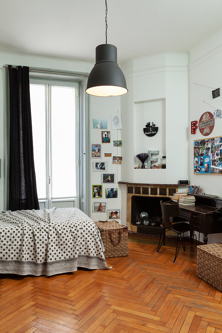 Bed, fireplace and antique desk in teenager's bedroom