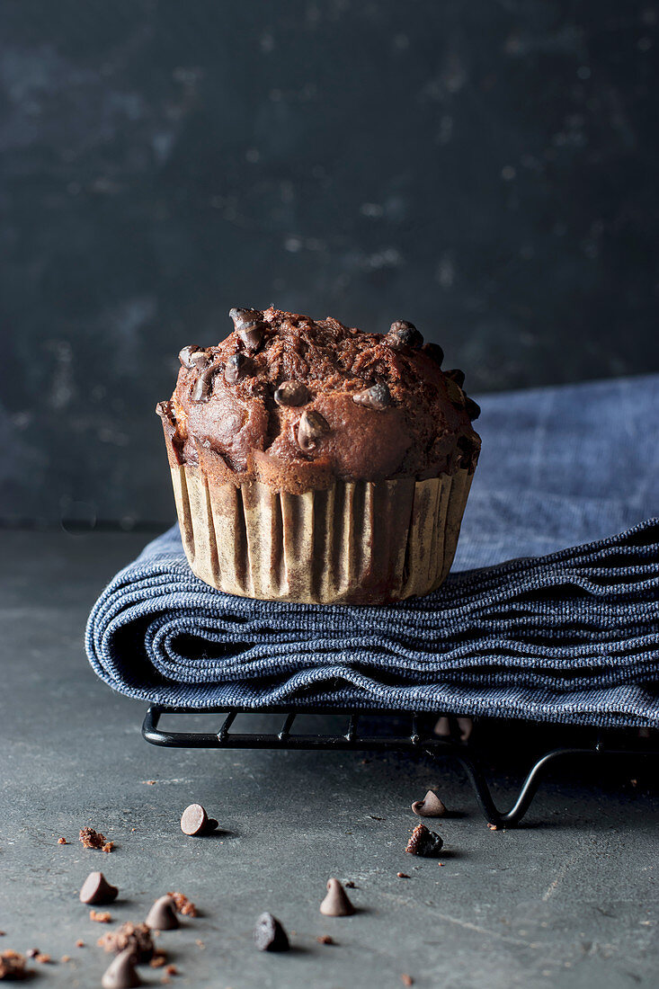 Yummy muffin made with chocolate and banana on blue towel