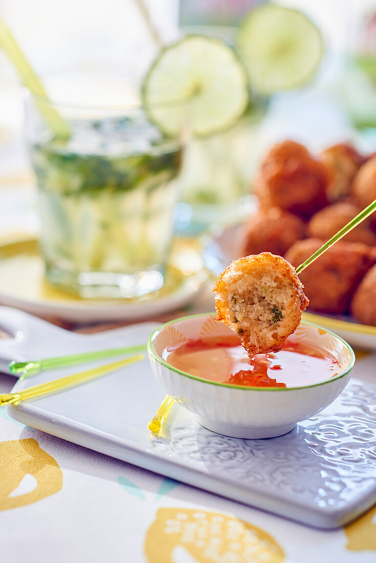 Acras de morue (stockfish balls, Caribbean) with a dip and a mojito
