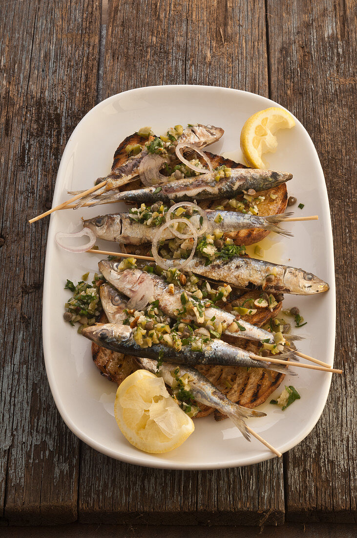 Grilled sardines with green herbs and almonds