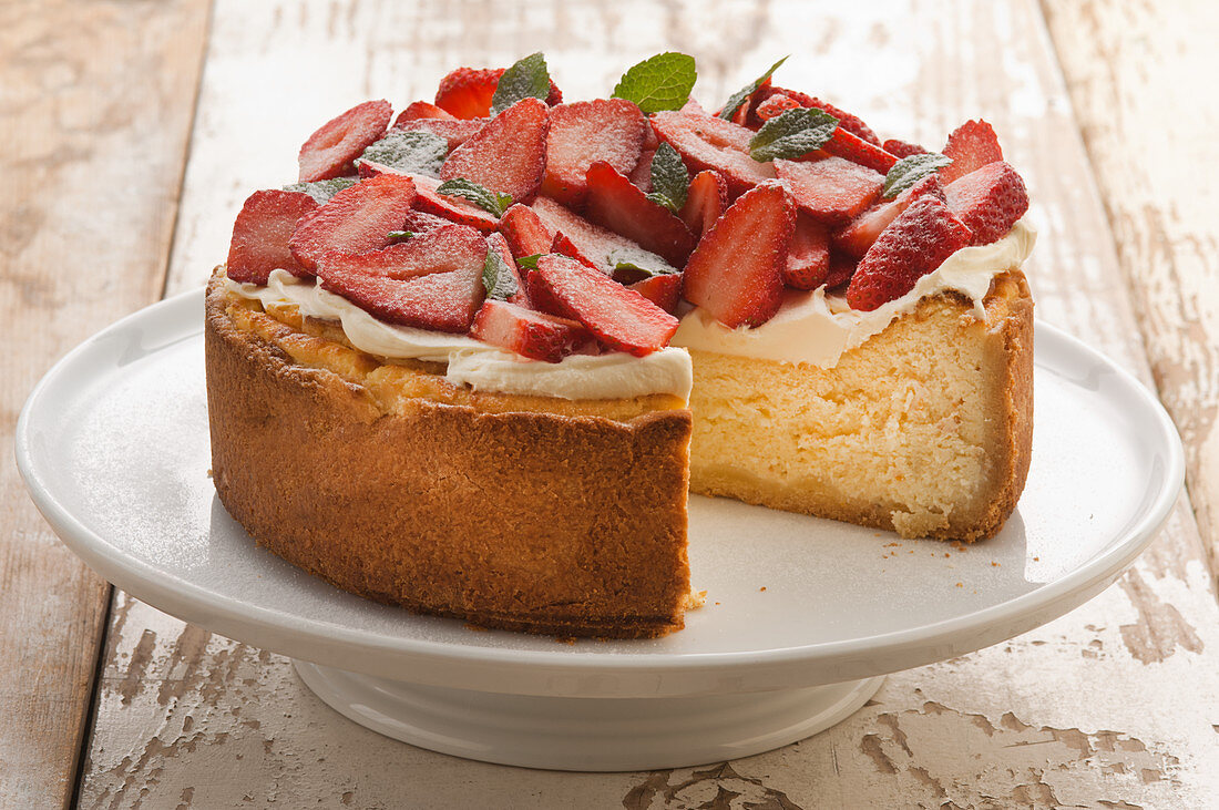 Classic cheesecake with whipped cream and fresh strawberries
