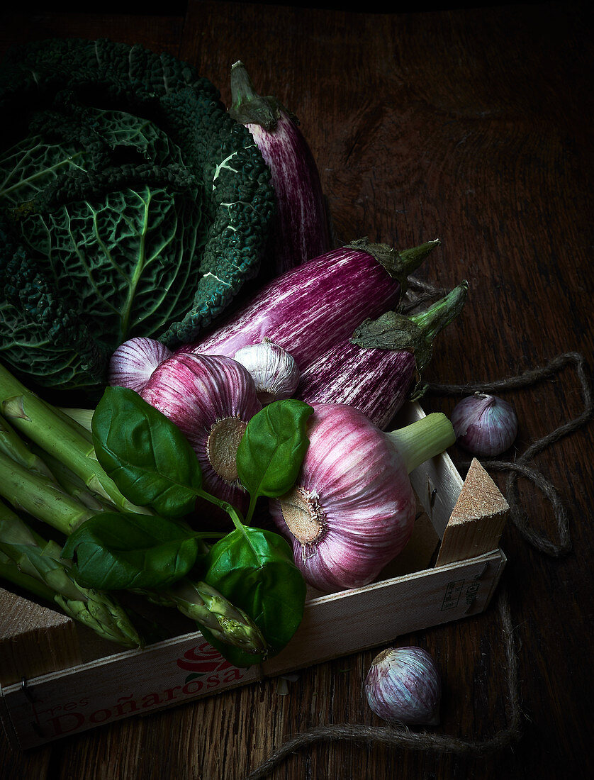 An arrangement of Savoy cabbage, garlic, basil and asparagus