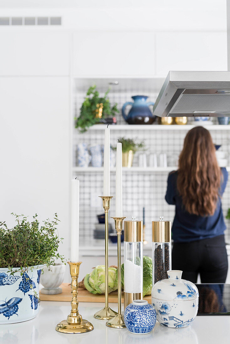 White, modern kitchen with classic accessories in blue and gold