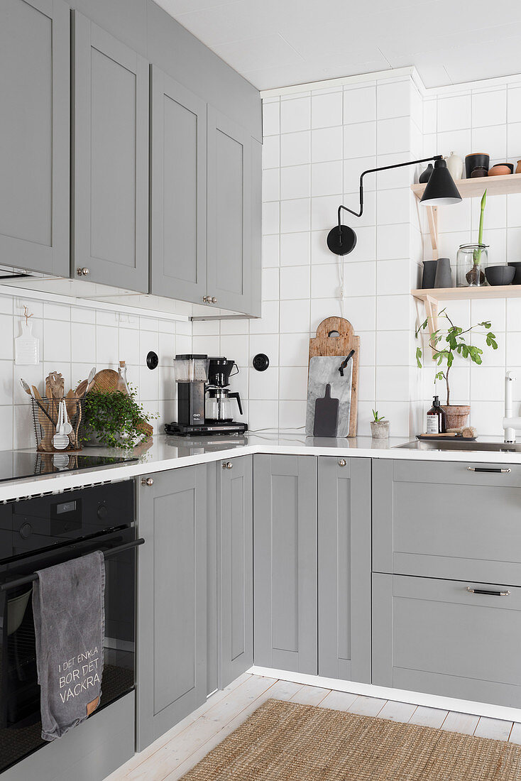 Country-house kitchen with stone-grey cabinets and white tiled walls