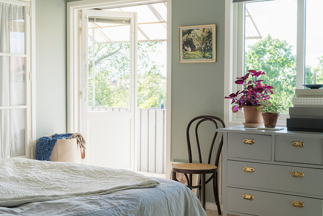 Classic bedroom in pale grey and white with balcony