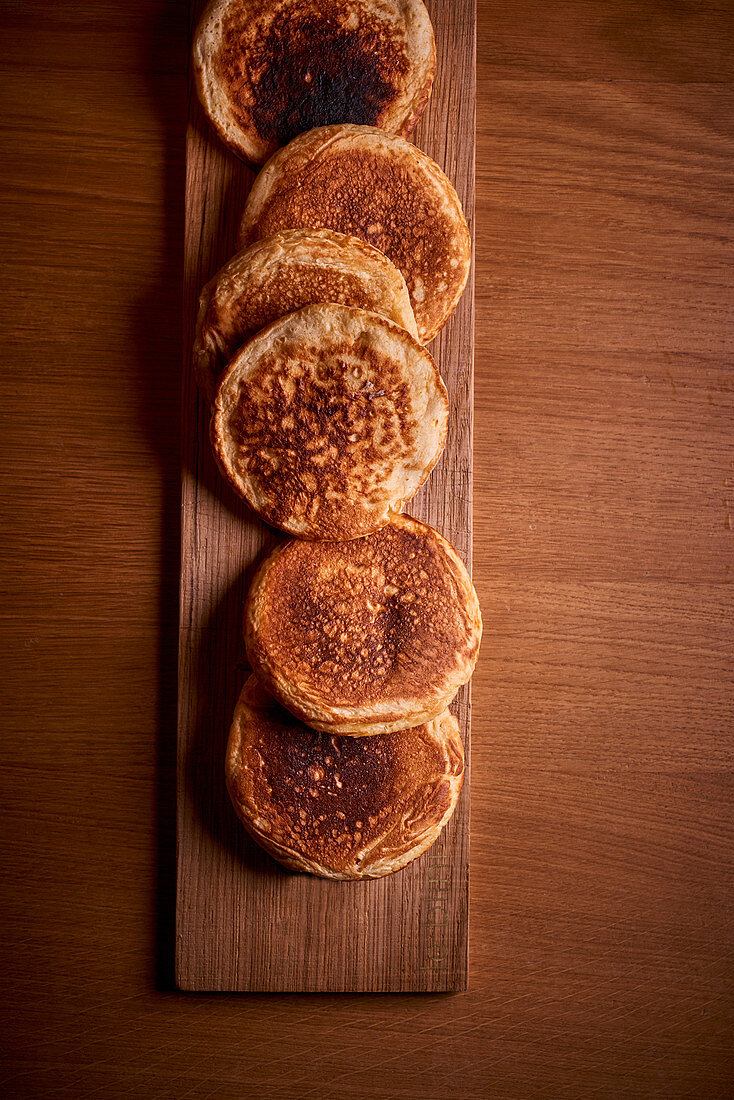 Blinis on a wooden board