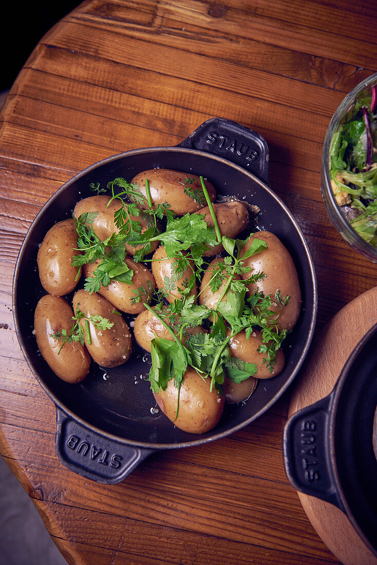 New potatoes cooked in their skins with fresh herbs