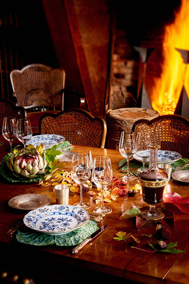 An autumnal laid table with red wine