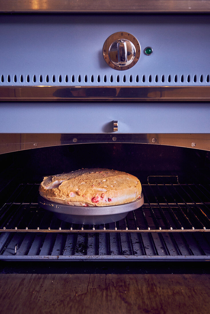 Gratinated floating island with berries in an oven