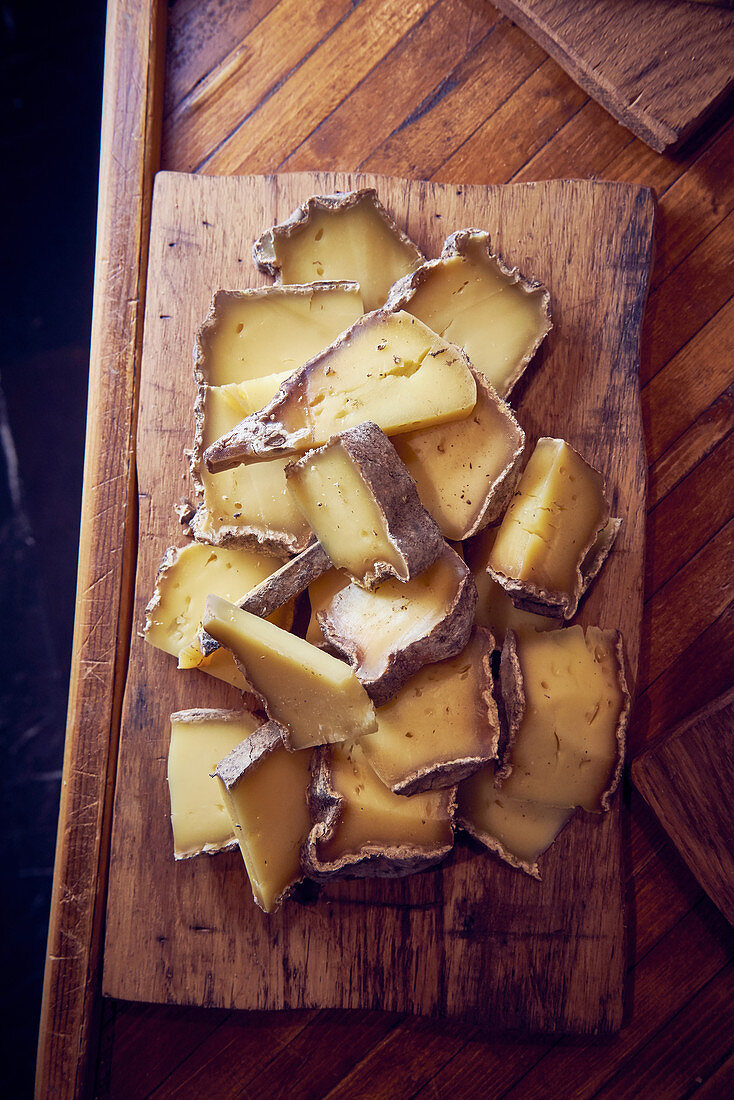 Sliced French cheese on a wooden board