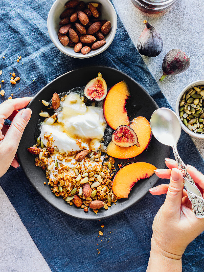 Yogurt bowl with granola, nuts and fruits