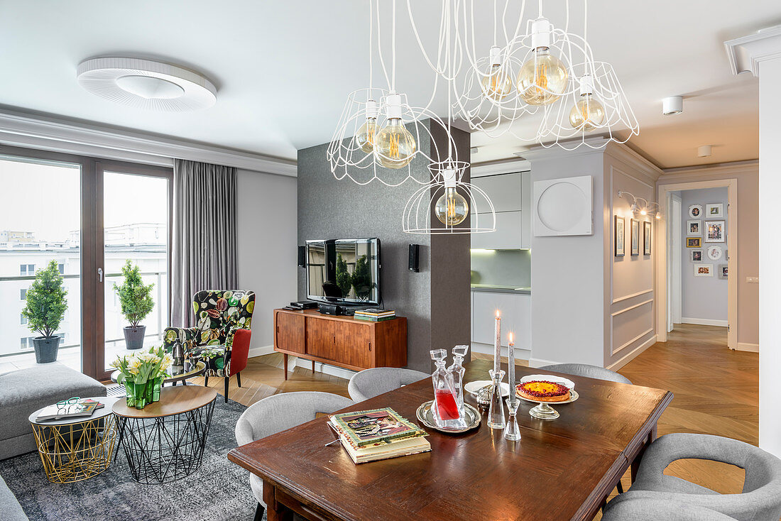 Grey walls and eclectic mix of furniture in open-plan apartment