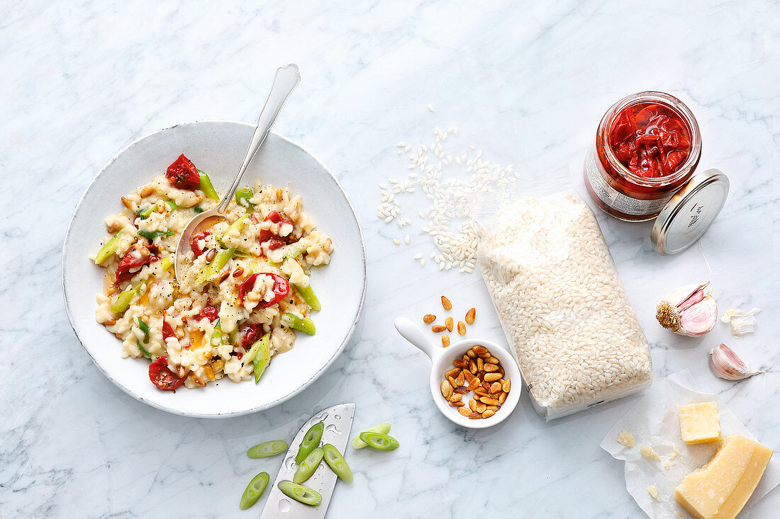 Risotto with dried tomatoes, pine nuts and spring onions