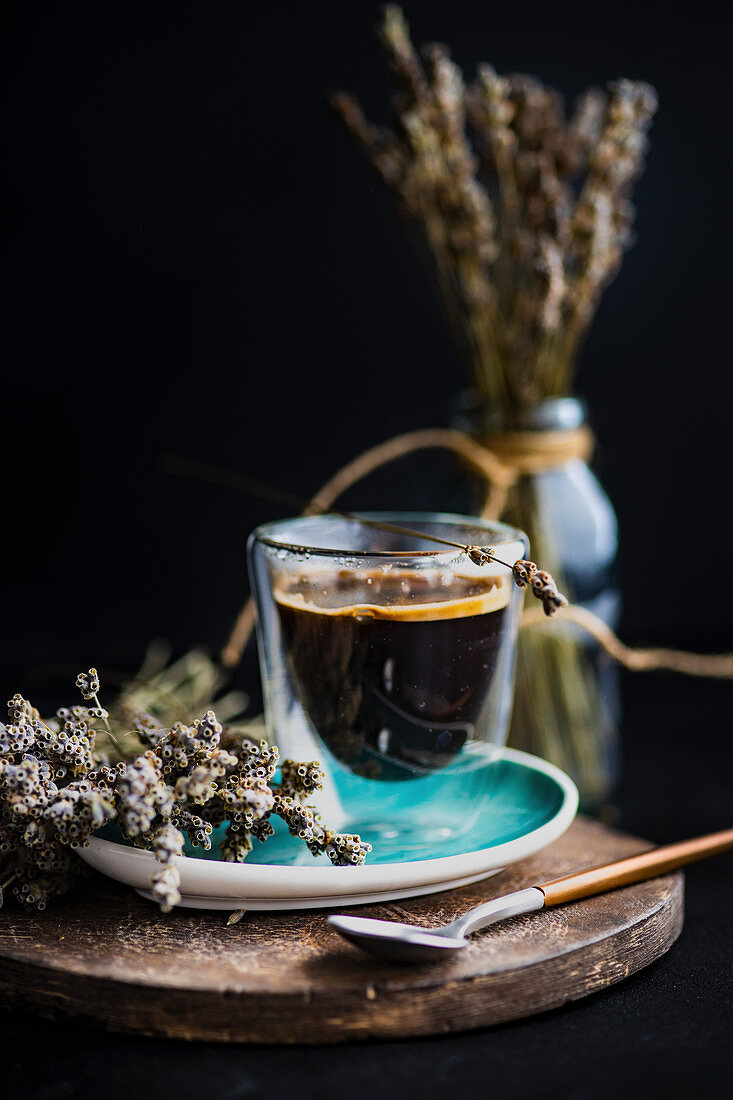 Coffee brak concept with dry laverder flowers and glass of coffee