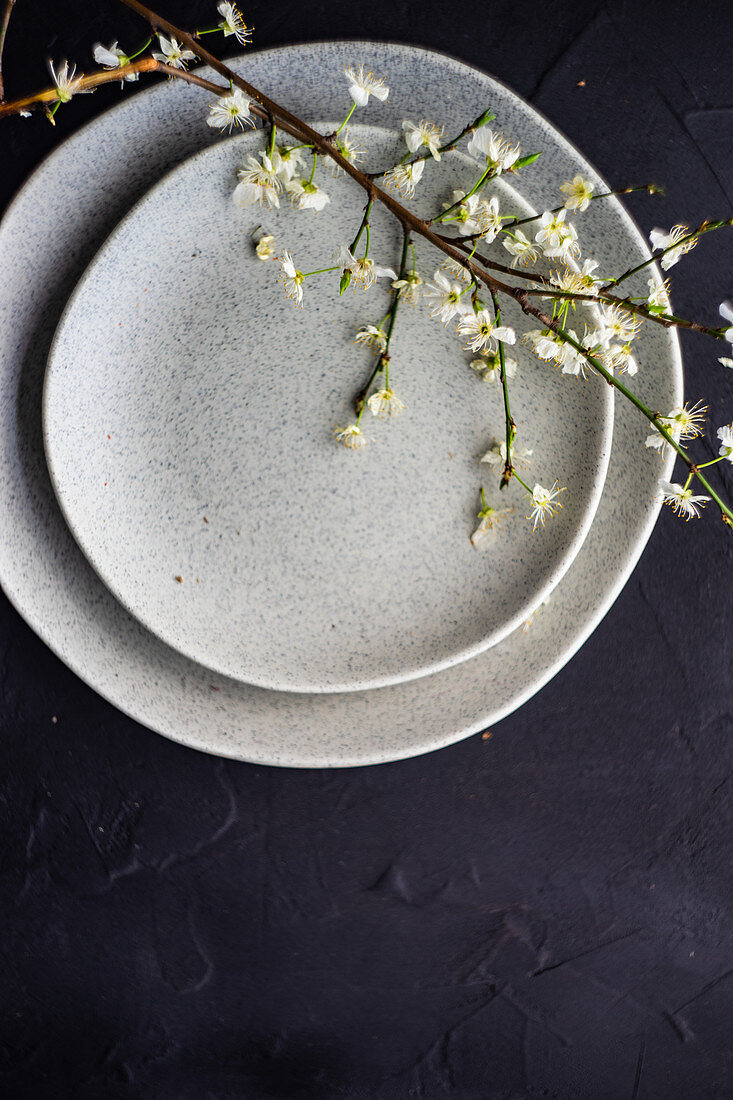 Spring table setting with peach blossom branch