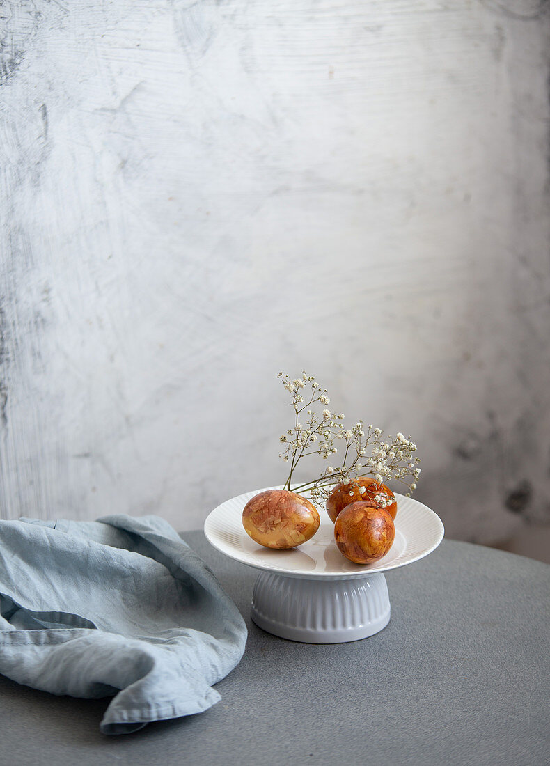 Easter Eggs, Naturally Dyed with Onion Skins, Flowers and Herbs on marble background