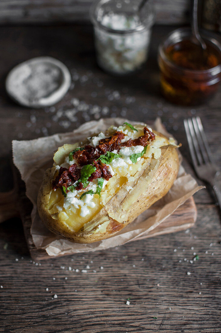 Baked potato with sun dried tomatoes and bryndza cheese