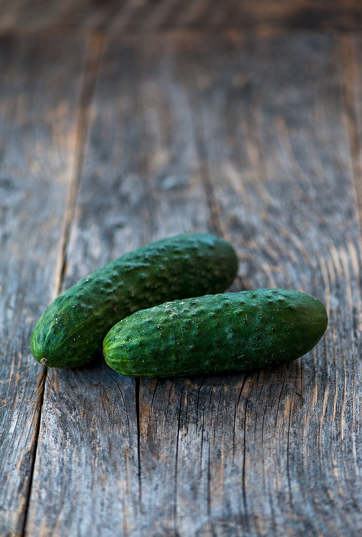 Two cucumbers on a rustic background