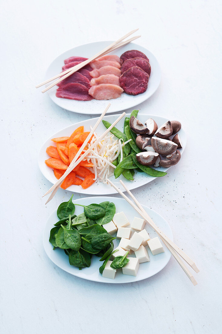 Sliced meat, vegetables and tofu for a fondue