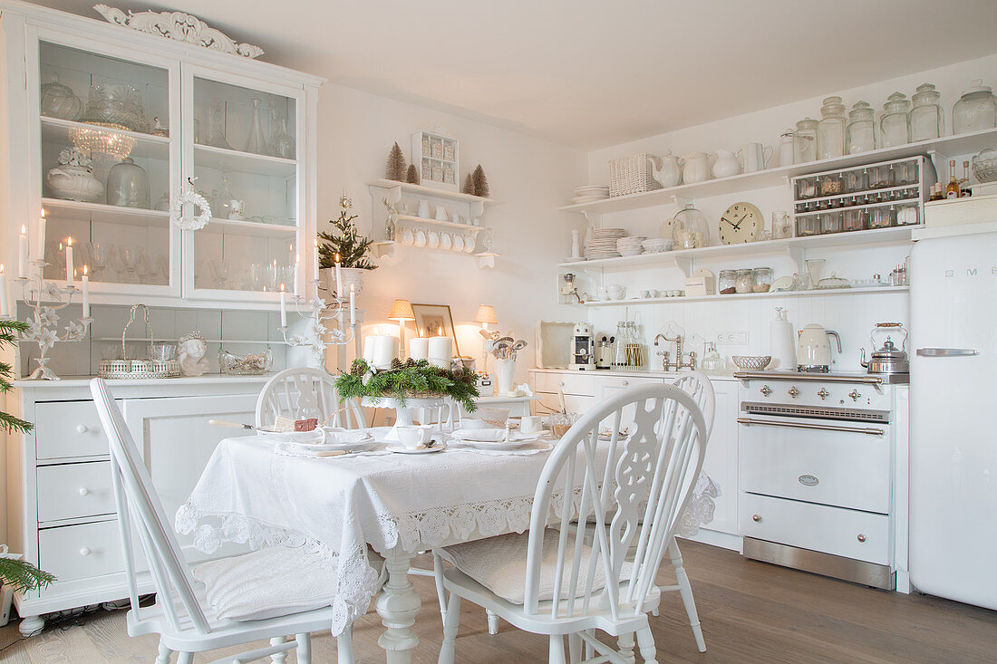 Vintage-style kitchen-dining room decorated entirely in white