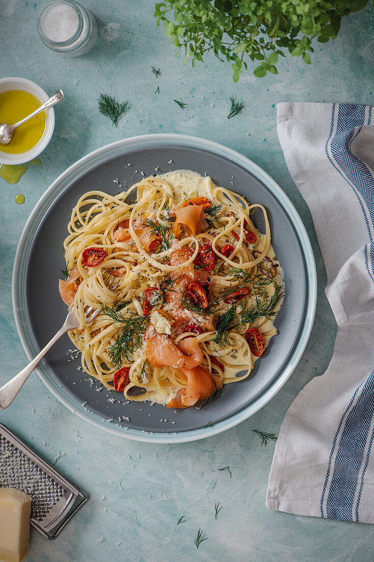 Smoked salmon pasta with creamy dill and garlic sauce, roasted cherry tomatoes and parmesan cheese