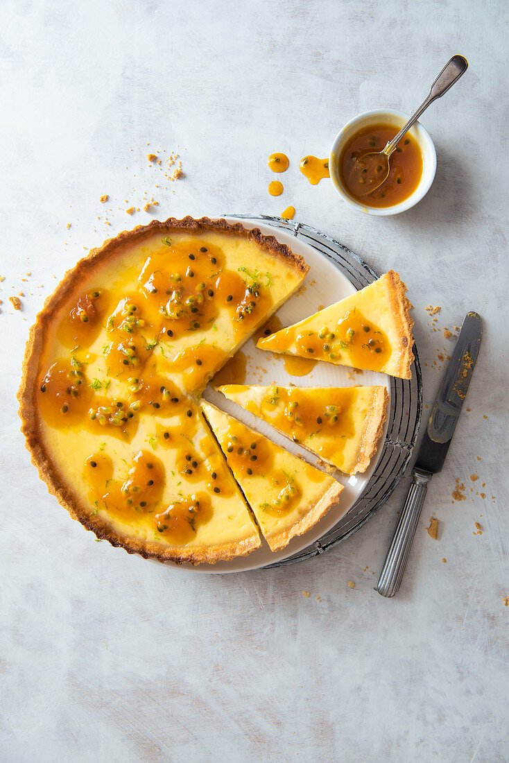 Lime and coconut tart with orange passion fruit sauce