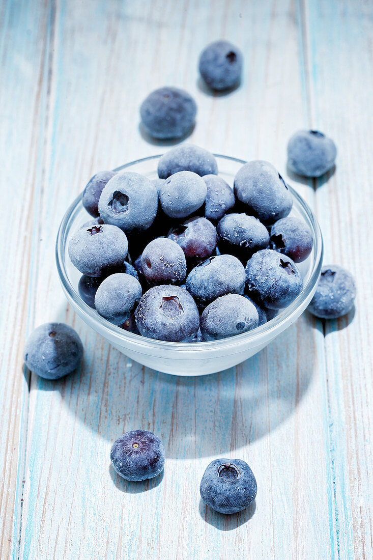 Frozen blueberries in a glass bowl