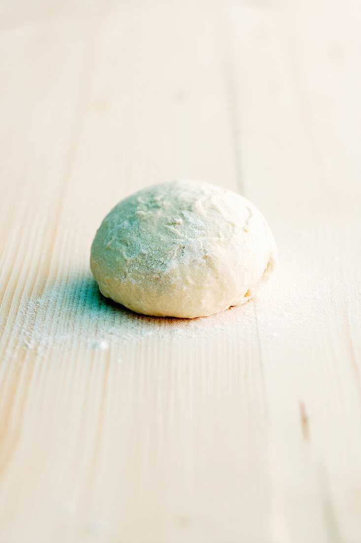 Pizza dough on a wooden surface