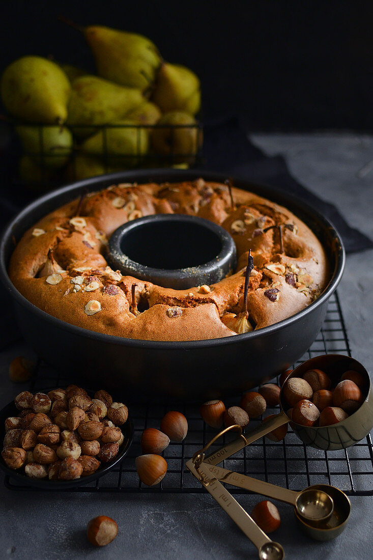 Cake with whole pears in a baking tray