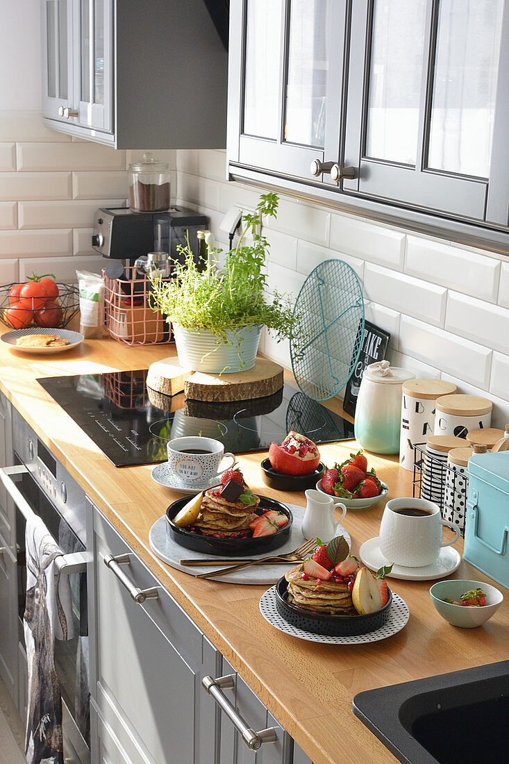 Fritters with fruit on plates kitchen top