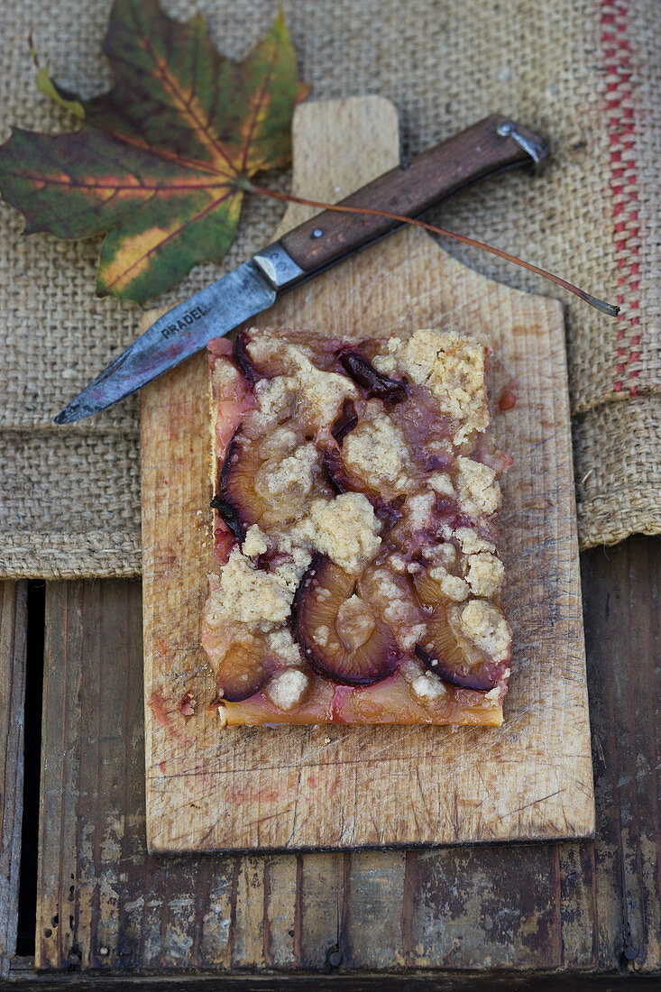 Zwetschgendatschi (plum crumble cake from Bavaria) on a wooden board