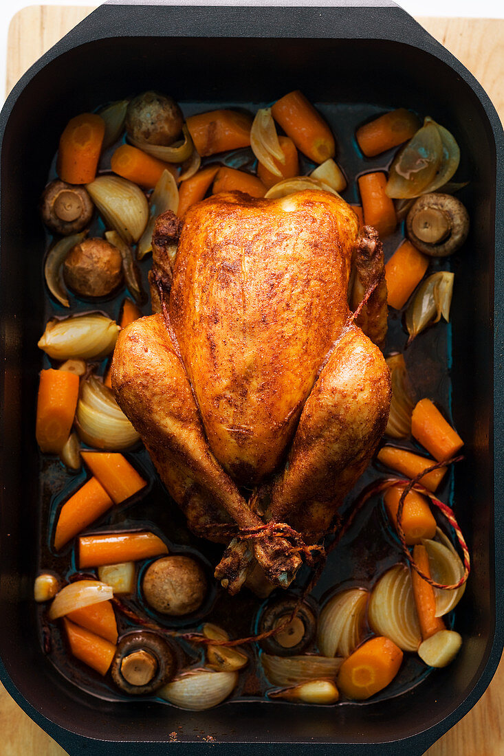 Roast chicken with carrots, onions and mushrooms