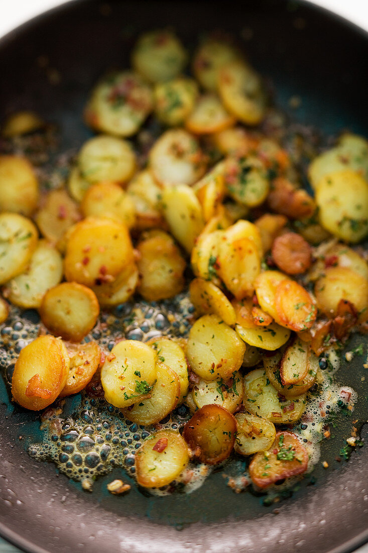 Fried potatoes in frying pan