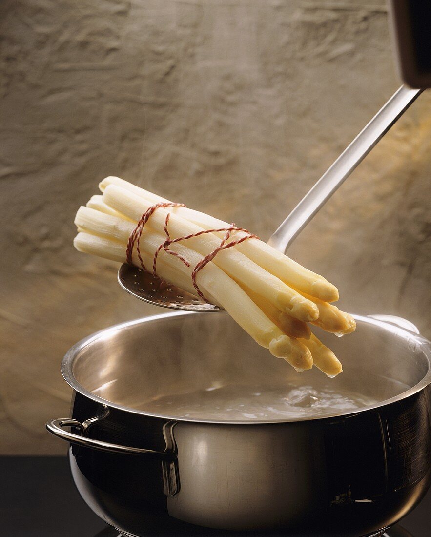 Lifting White Asparagus from Pot of Boiling Water