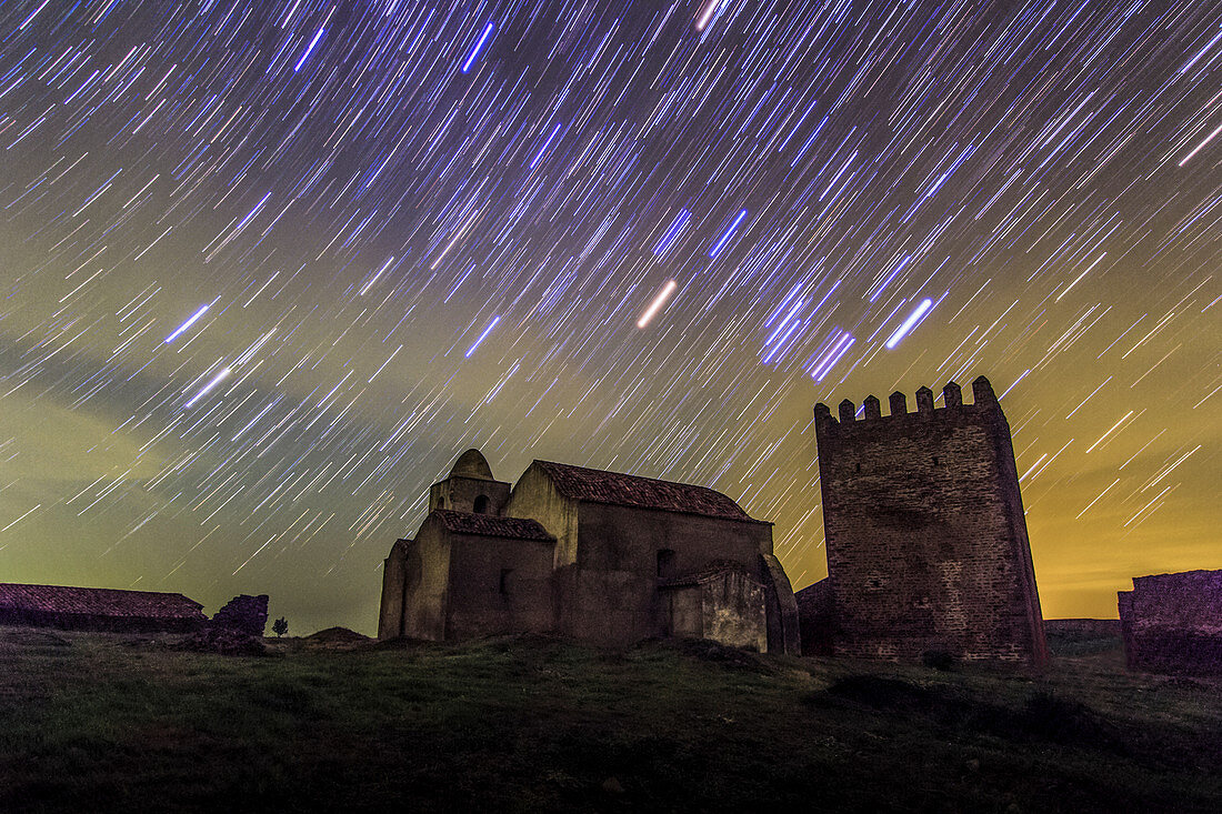 Star trails over Noudar Castle, time-exposure image