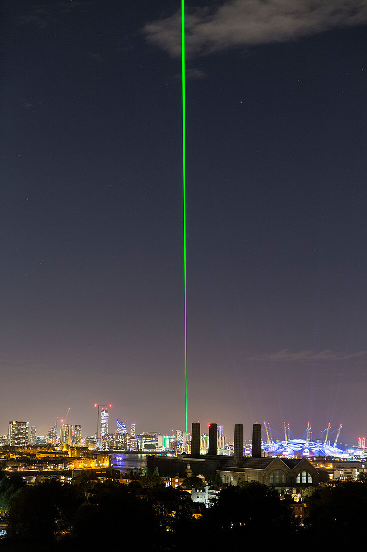 Greenwich Meridian laser shining over London at night