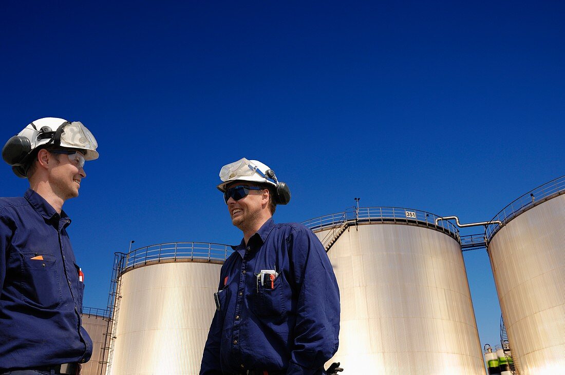 Oil workers and fuel storage tanks