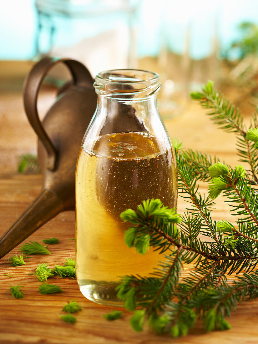 Homemade pine syrup in a glass bottle with a vintage funnel