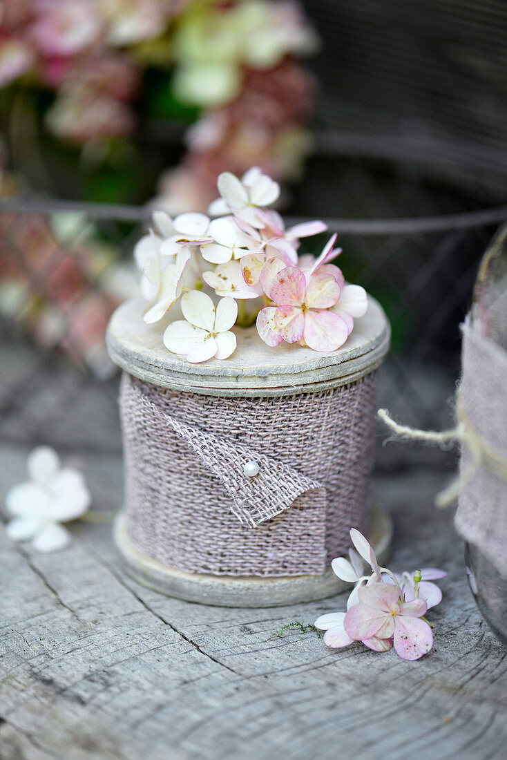 Reel of hessian ribbon decorated with hydrangea florets