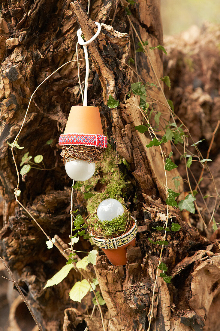 Lantern lampshades hand-made from terracotta pots decorated with fabric trim