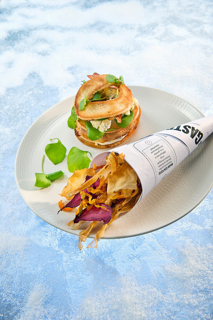 Natural cuisine: a bagel with quail served with fried root vegetables crisps