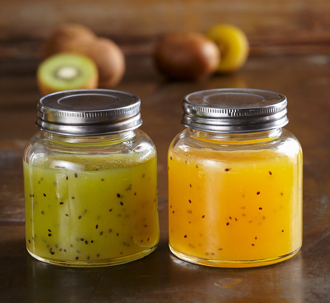 Glasses of homemade yellow and green kiwi syrup