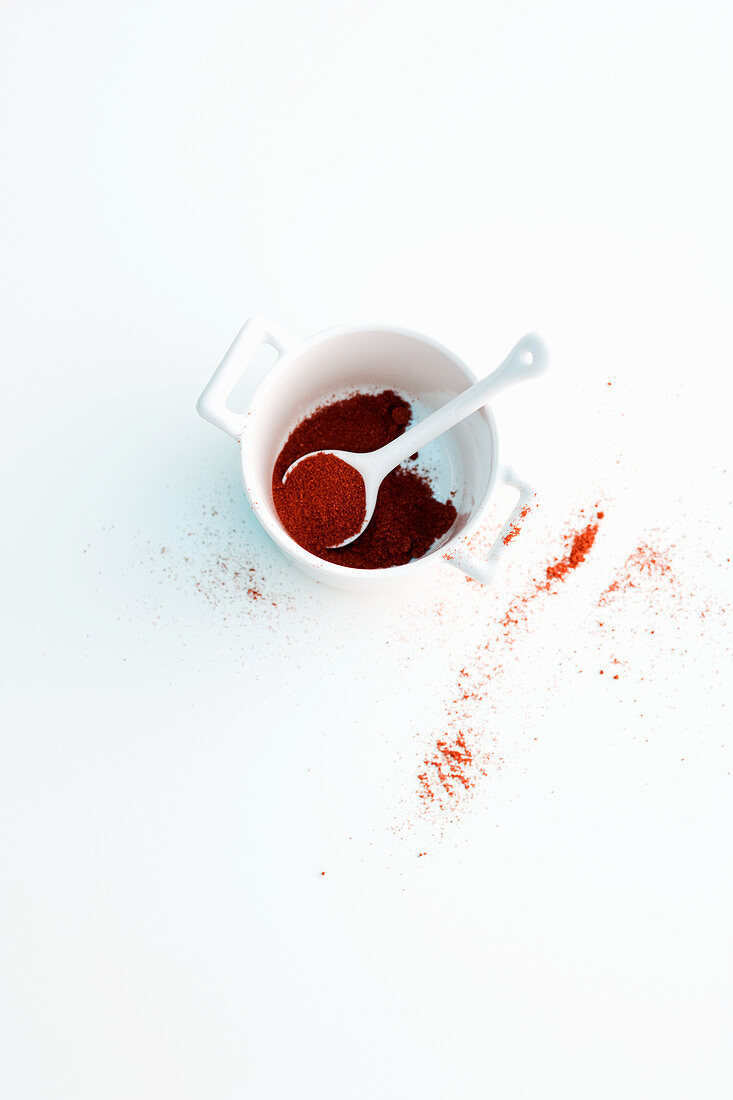 Paprika powder in a cup with a spoon