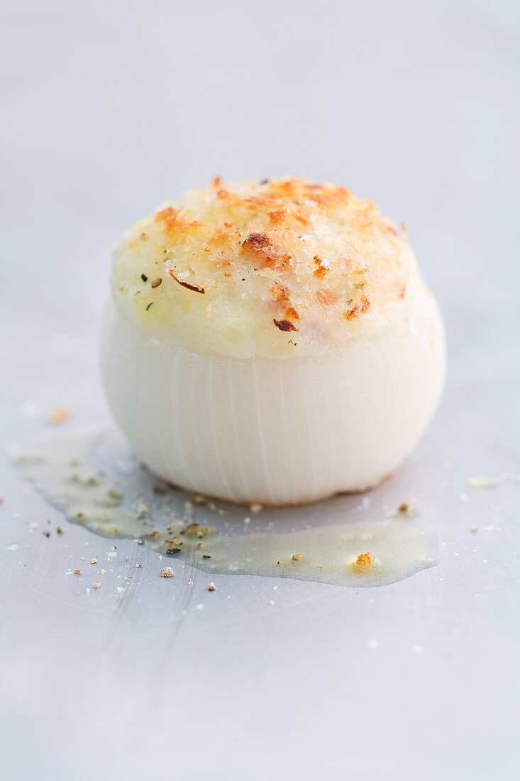 A stuffed onion filled with bacon and cheese