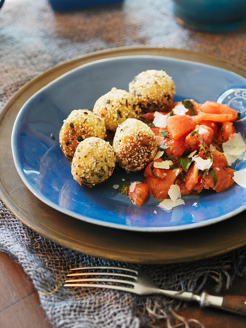 Spicy millet balls with a tomato salad