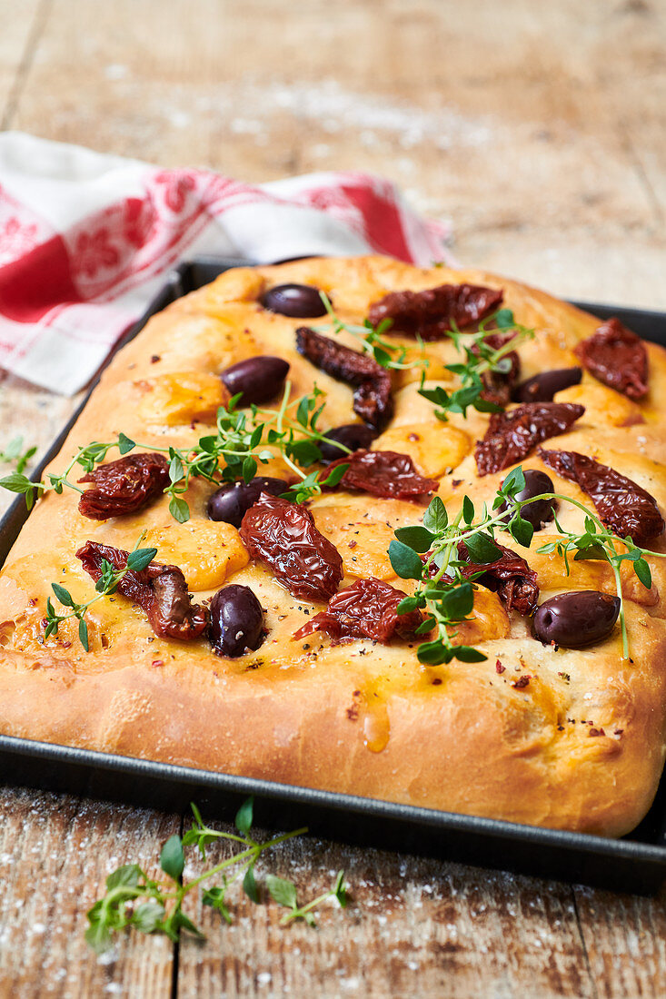 Focaccia with Cheddar, dried tomatoes, olives and herbs