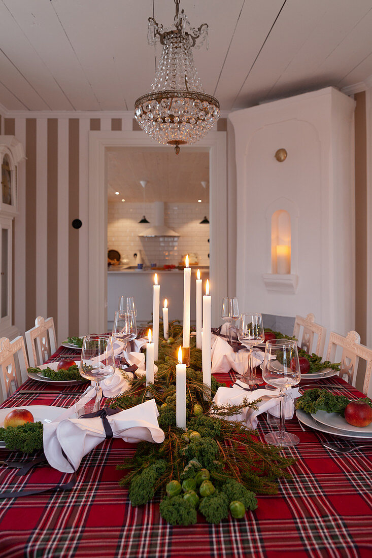 Festively set dining table decorated with kale