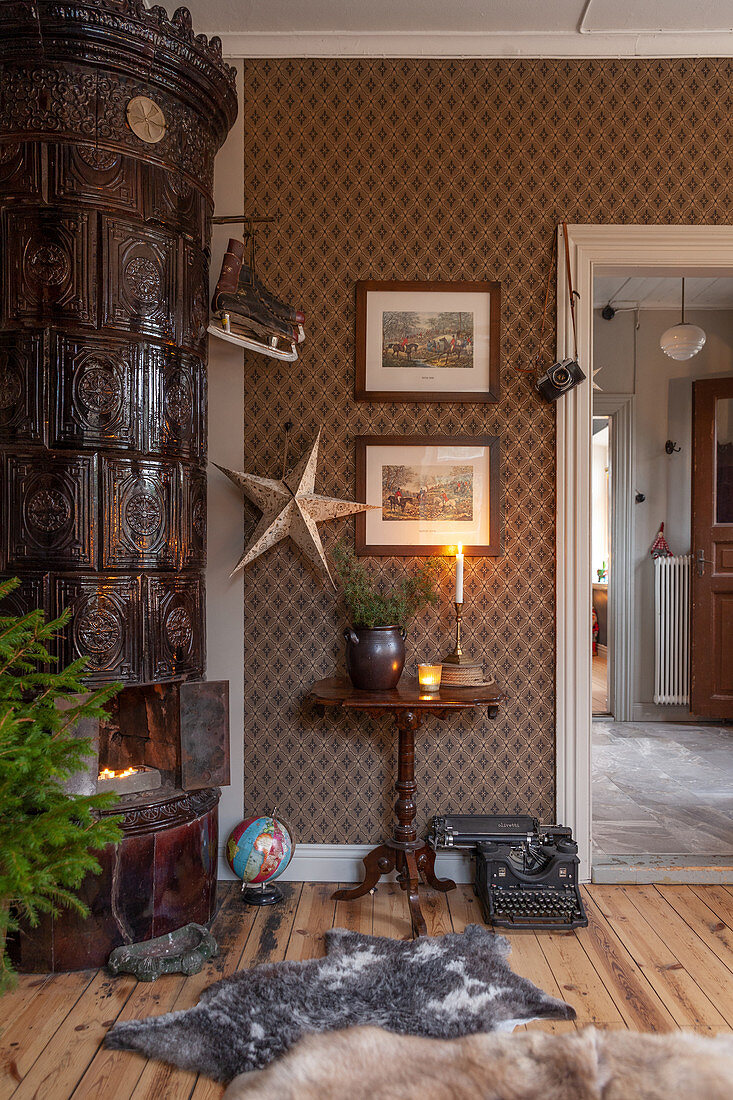 Dark tiled stove in corner of festively decorated living room