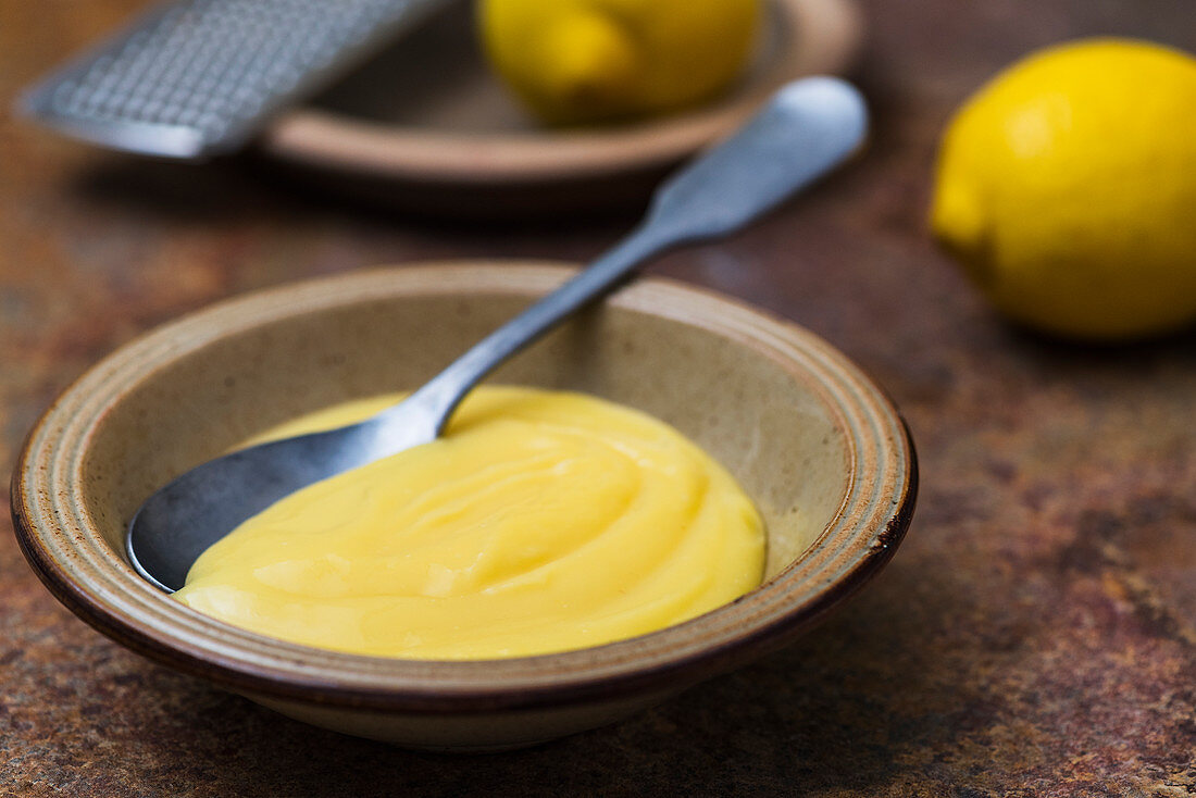 Lemon curd in a bowl with a spoon