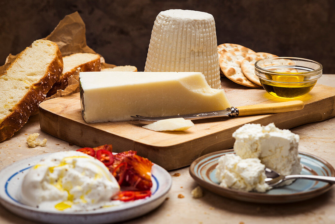 A cheese platter with olive oil and bread